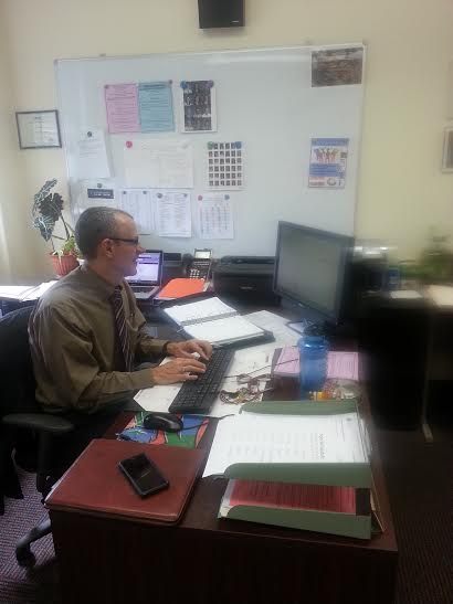 Academic Dean David Ruiz chips away at his    workload in his office.