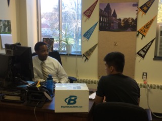 Nulan converses with     senior Hiep Nguyen in  his office. Photo taken by Dollar Zhu.