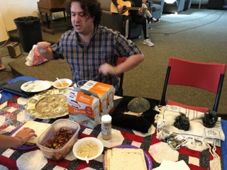 Math teacher Caleb Parsons enthusiastically examines the food before him.