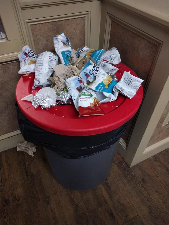 An overflowing trash bin in the MacDuffie cafeteria.