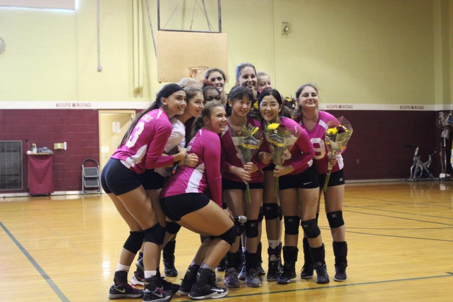 MacDuffie Girls Volleyball celebrates their seniors while wearing pink uniforms for Breast Cancer Awareness Month.