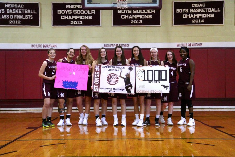 MacDuffie+Girls+Varsity+Basketball+team+poses+with+senior+Jocelyn+St.+Onge+after+she+scored+her+thousandth+point+on+January+6th%2C+2018.+PC%3A+Amy+Cauley