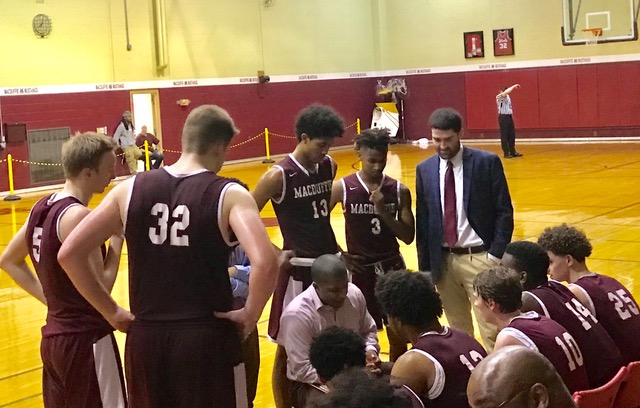 Coach Jacque Rivera discussing the game plan with the Boys’ Prep Basketball Team. Photo by Sarah Hoffman.