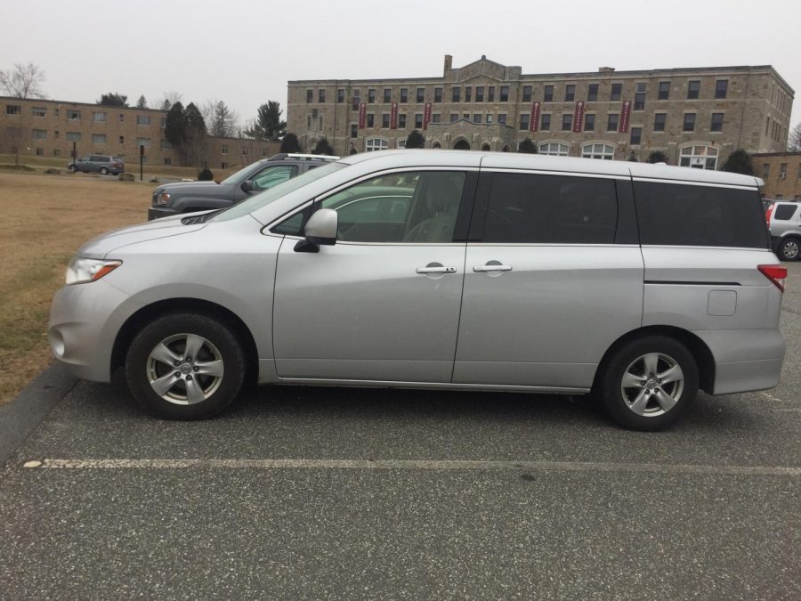 A MacDuffie minivan sitting outside the schools main building in the parking lot. This is the same model of the minivan that caught on fire; however there are some changes such as the color. Photo by Marie Hua