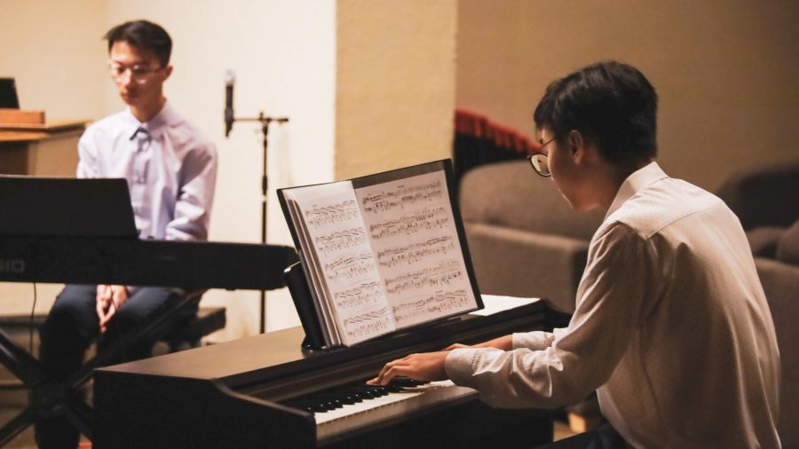 Senior Ryan Đoàn and sophomore Phillip Duan are playing a musical piece at the piano concert fundraiser. Fundraiser was held to purchase a new piano for the MacDuffie School.