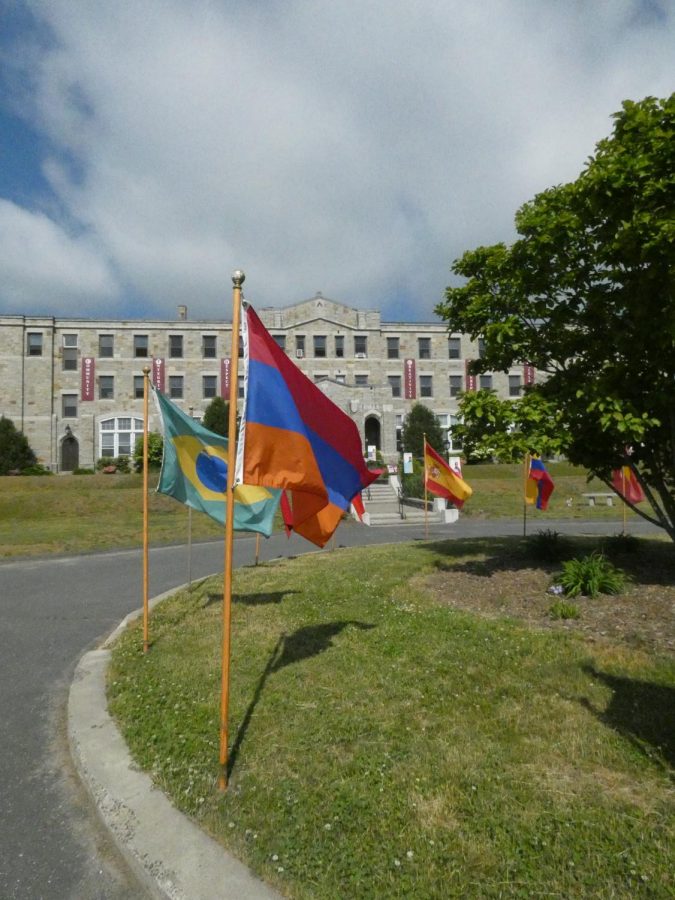 Flags from the countries of MacDuffies students fly in front of the school at graduation in 2020. This tradition is meant to reflect and honor the large international population at the school.