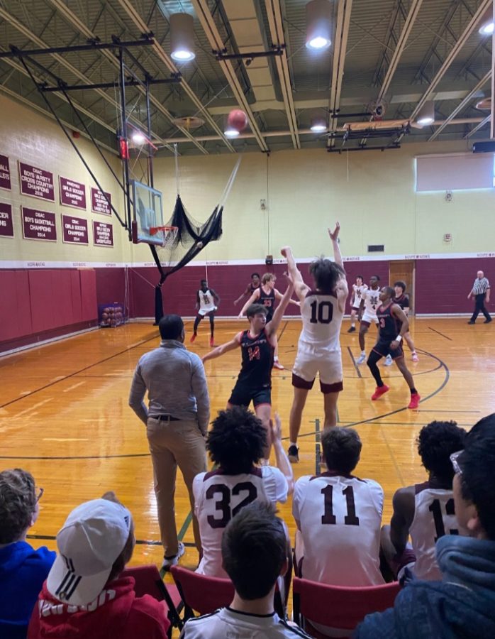 A MacDuffie player sends a potential three-pointer into the air. Photo provided by the MacDuffie School. 
